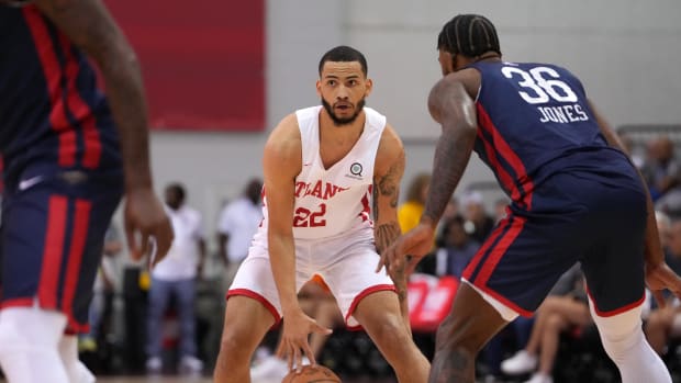 Atlanta Hawks guard Tyrese Martin (22) dribbles against New Orleans Pelicans center Tyrique Jones (36) during an NBA Summer League game at Cox Pavilion.